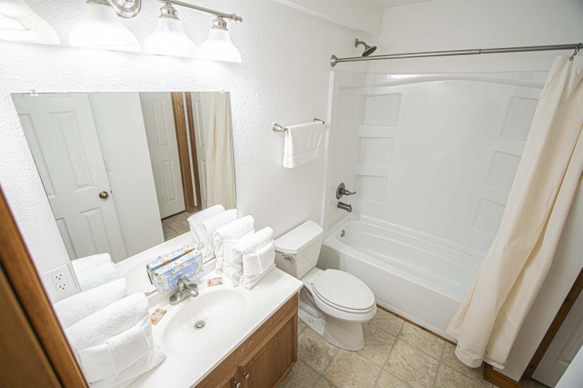 Bathroom Photo - Photo shows bathroom with towels and toiletries